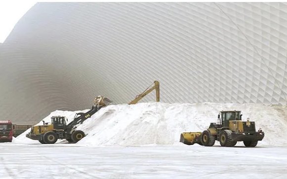 Loaders working bulk material under a dome